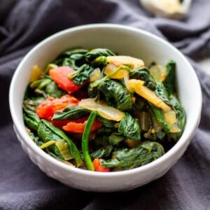 cooked spinach in white bowl