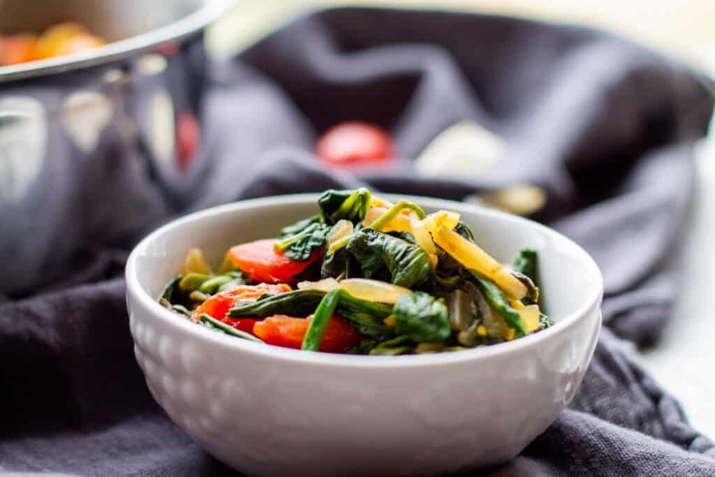 cooked spinach in white bowl