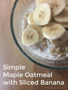 sliced bananas on top of oatmeal with almond milk and maple syrup
