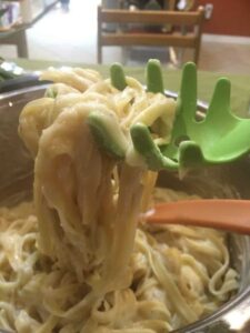 creamy cauliflower alfredo sauce with pasta in a pot