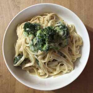 creamy cauliflower alfredo sauce with pasta in a bowl close-up