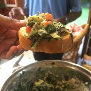 vegan spinach artichoke dip on crostini bread by very veganish