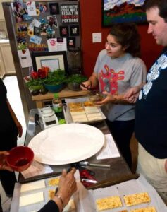 cooking class participants marinating tofu