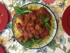 eggplant meatballs with marinara sauce on top of spaghetti