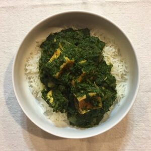 vegan saag paneer in bowl of rice