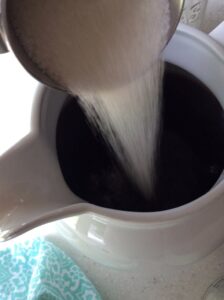 pouring sugar in tea