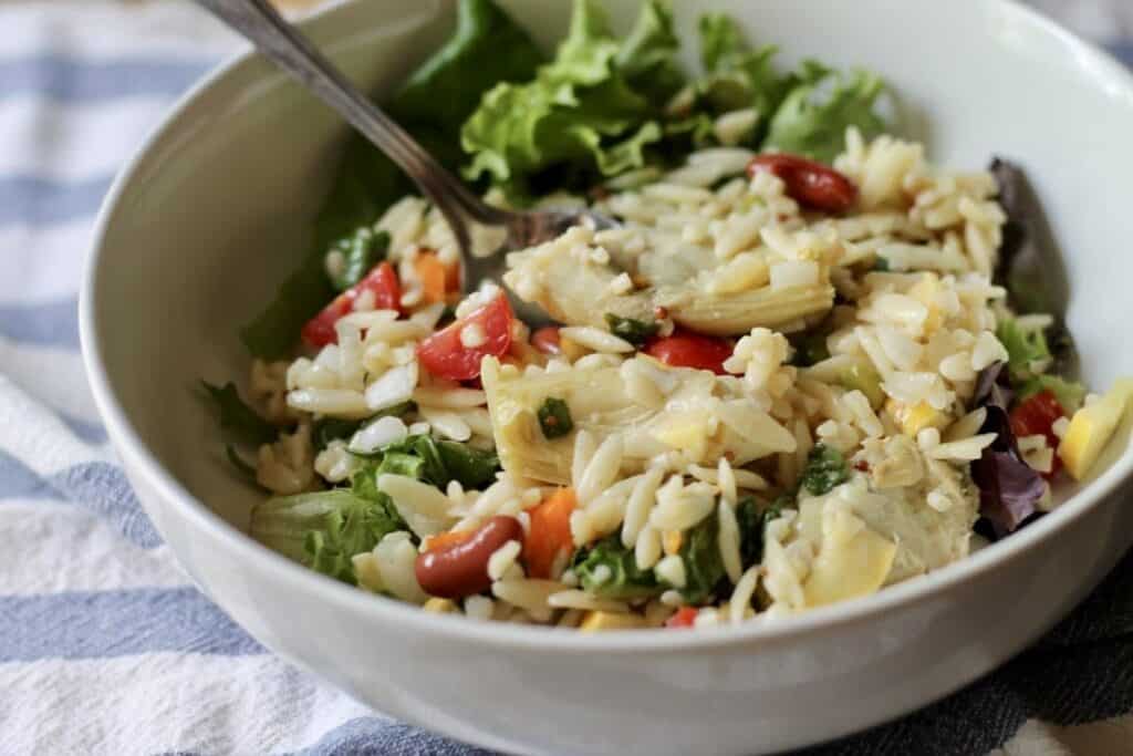 finished salad in white bowl with a spoon