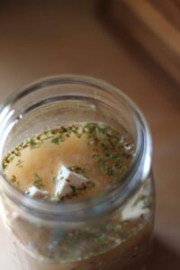 tofu feta cheese marinating in a jar