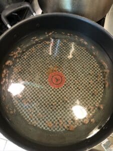 water and salt added to pan with cumin seeds for jeera rice