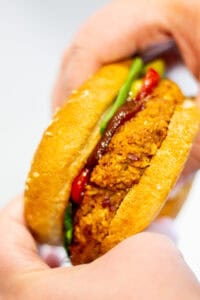 holding a red kidney bean burger