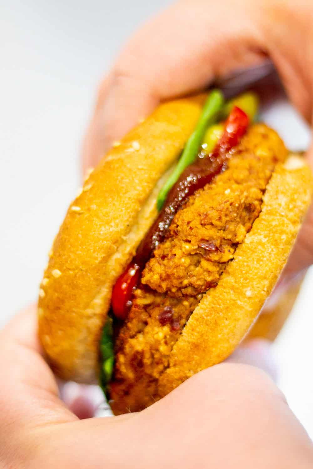 holding a red kidney bean burger