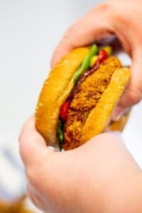 holding a red kidney bean burger