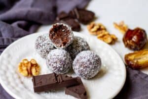 finished chocolate coconut date balls on a plate