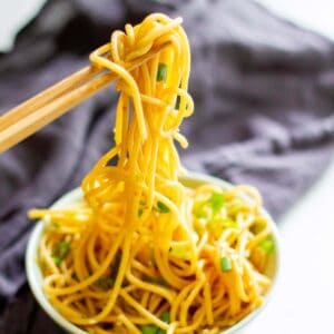 chopsticks holding noodles