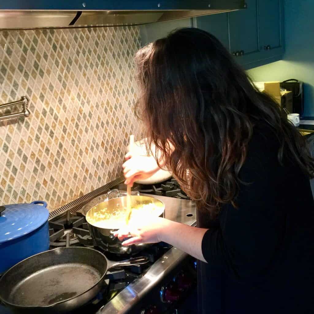 abi cowell cooking over stove