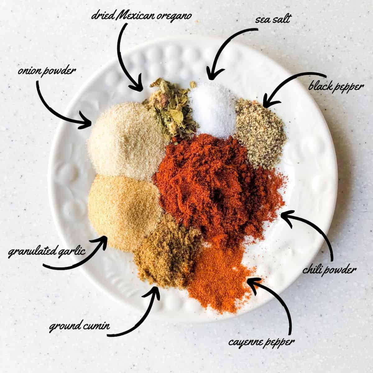 spices ingredients for chili: dried mexican oregano, sea salt, black pepper, chili powder, cayenne powder, ground cumin, granulated garlic, onion powder