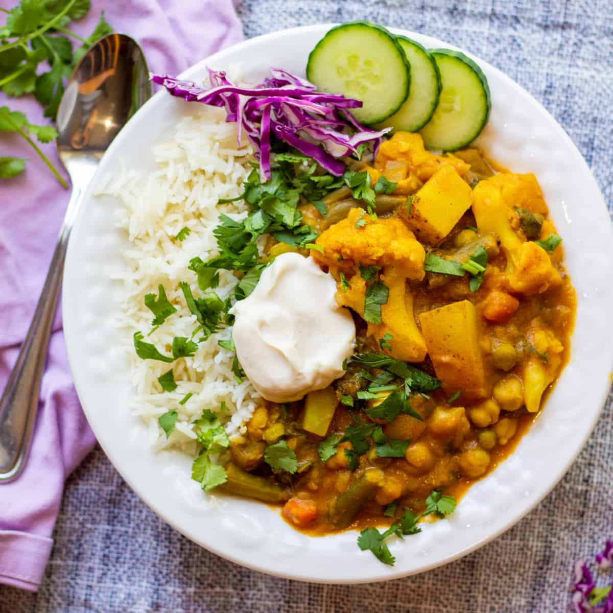 white bowl with rice and veggie korma