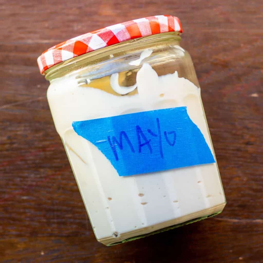 mayo in glass jar with blue painters tape label reads mayo