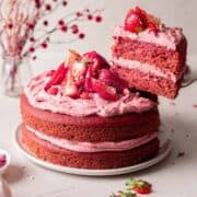 cutting a slice of strawberry cake