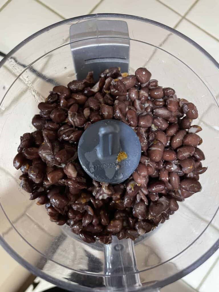 step 1: add drained black beans to mini food processor