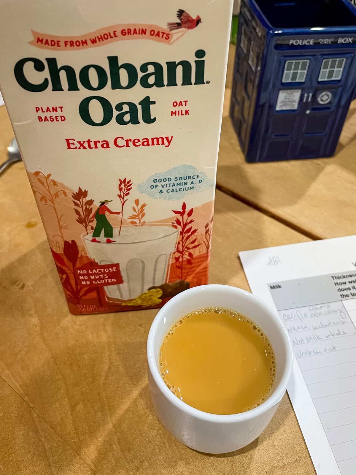 Chobani Oat Extra Creamy carton with cup of yorkshire gold black milk tea in front
