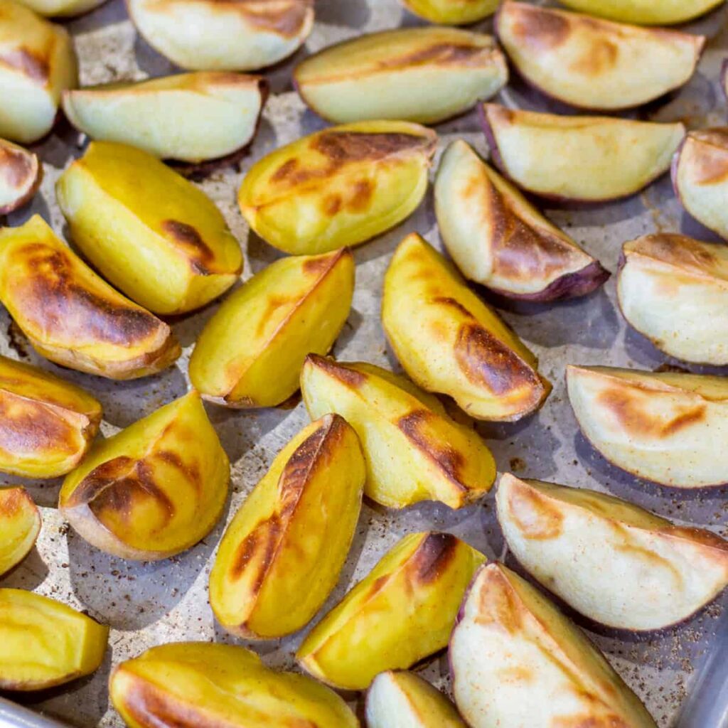 roasted potato wedges on a sheet pan