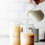 pouring milk into iced chai