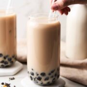 jasmine milk boba tea in glass with straw