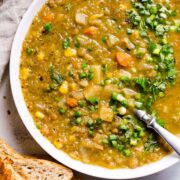 slow cooker lentil soup in bowl with toast on side