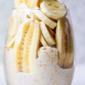 overnight oats with sliced banana in glass