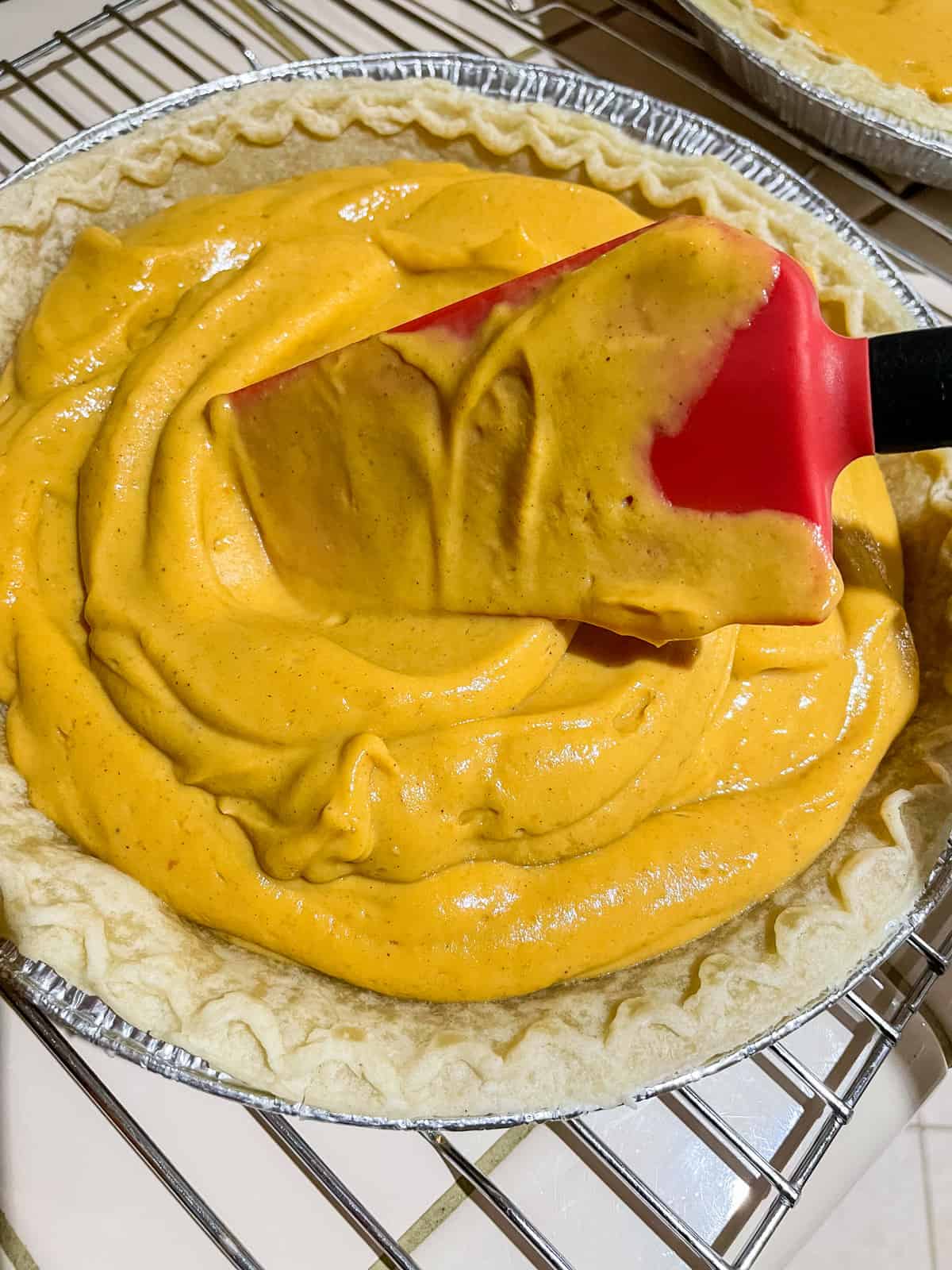 spreading filling into pie crust with silicone spatula