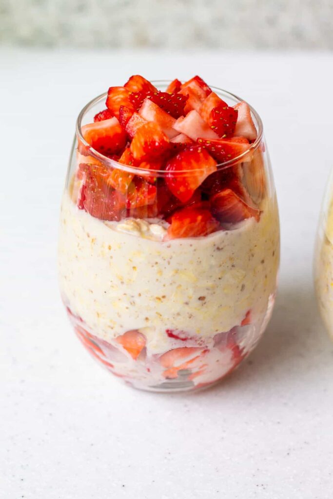glass with overnight oats and fresh strawberries
