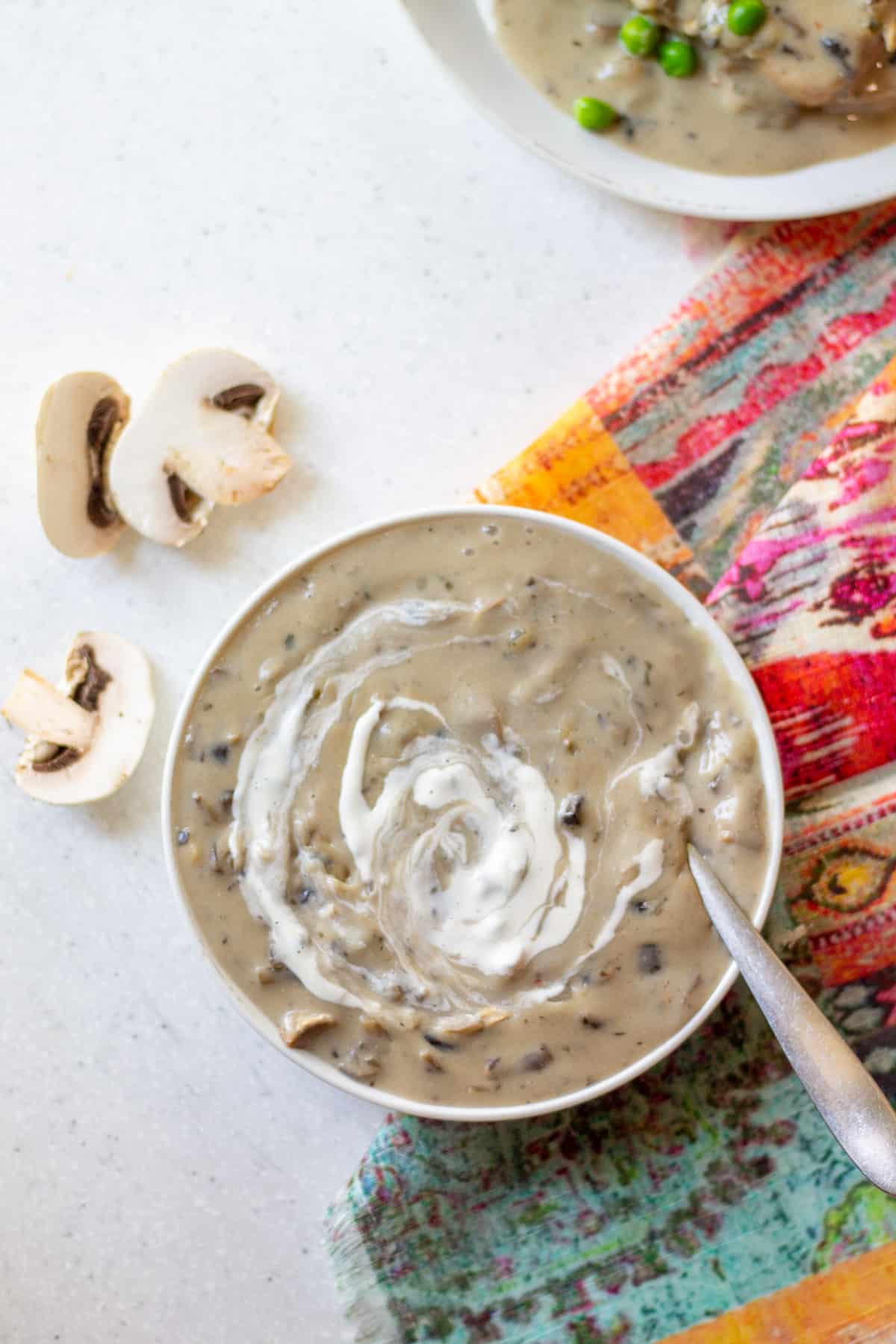 bowl of cream of mushroom soup with cashew sour cream swirled in