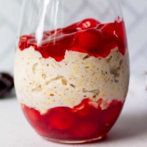 pretty glass with layers of premium cherry pie filling and vegan overnight oats