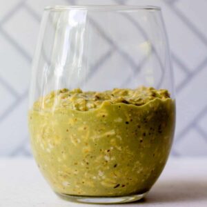 glass with matcha latte overnight oats in it
