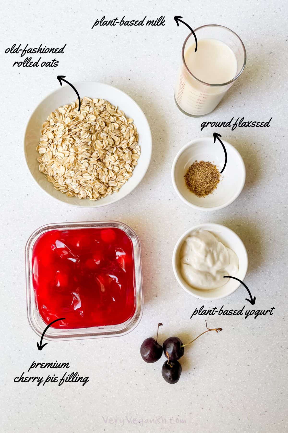 Ingredients for cherry pie overnight oats: rolled oats, plant-based milk, ground flaxseed, plant-based yogurt, premium cherry pie filling