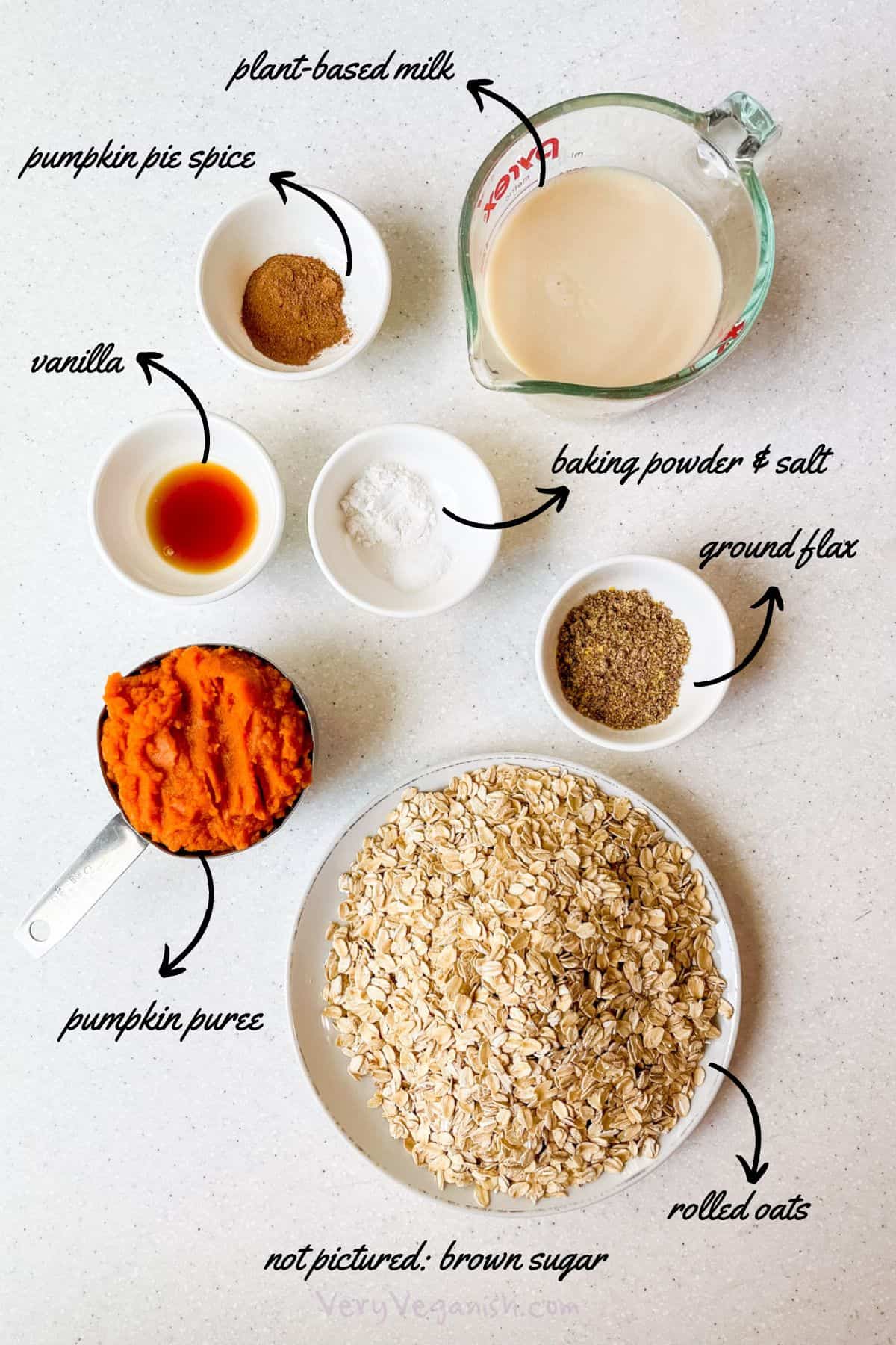 Ingredients for pumpkin pie baked oats: rolled oats, plant-based milk, pumpkin puree, vanilla, pumpkin pie spice, brown sugar, baking powder, salt and ground flax