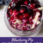 glass full of premium blueberry pie filling and overnight oats with fresh blueberries on side with title blueberry pie overnight oats, only 337 calories