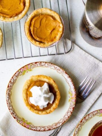 mini pumpkin tart on plate, with more cooling on rack