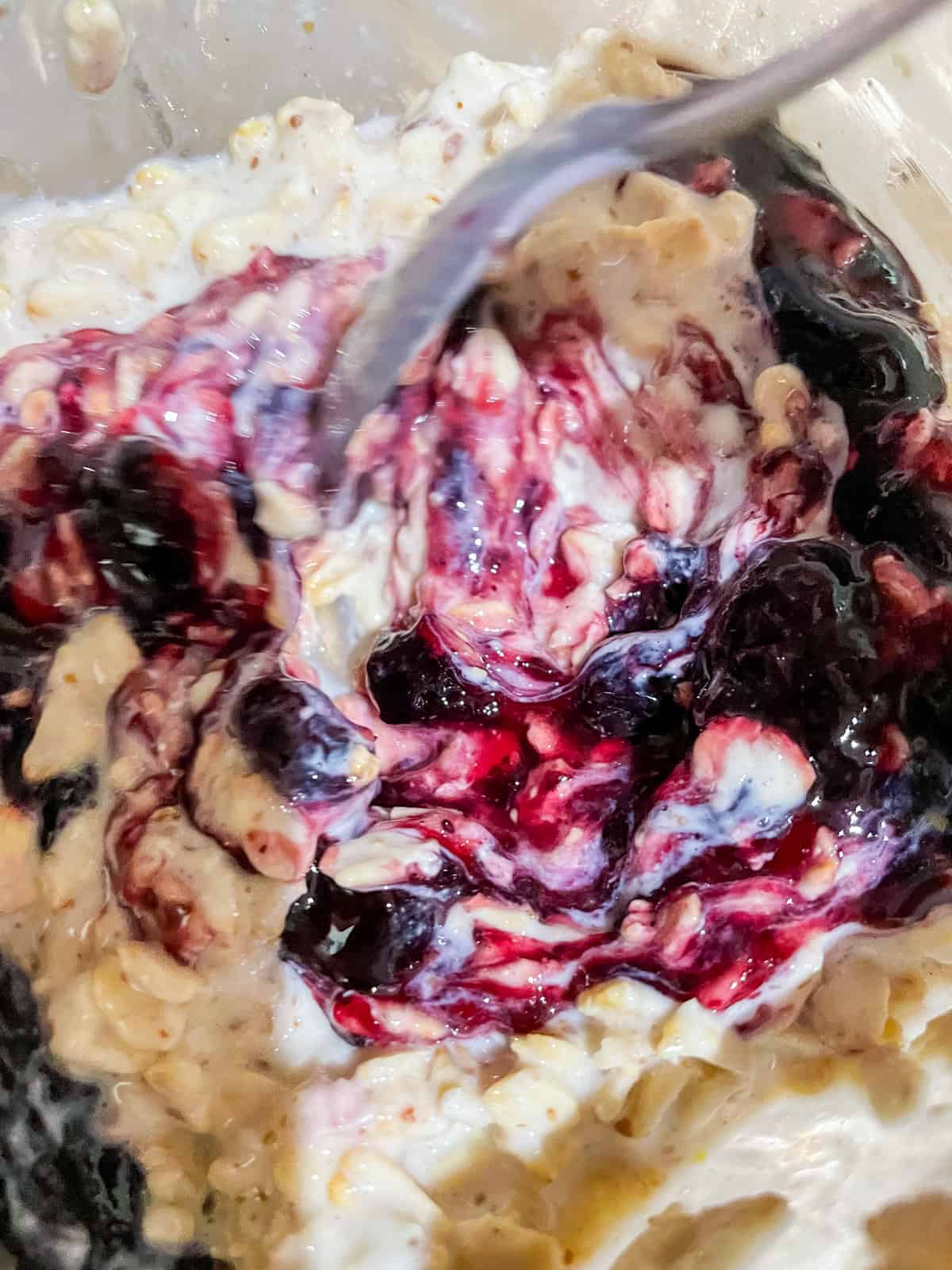 stir in blueberry jam to oats for blueberry overnight oats