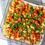 air fryer basket full of spicy potatoes