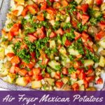 pinterest image with air fryer basket full of spicy potatoes and a title that reads "air fryer mexican potatoes with jalapeno, tomato, onion - vegan, oil-free, low calorie"