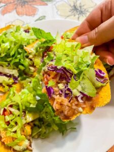 breaking tostada into lots of pieces, like chip size pieces to eat it like nachos