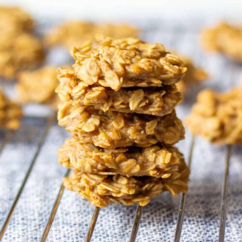 5 small banana oat peanut butter cookies stacked on rack