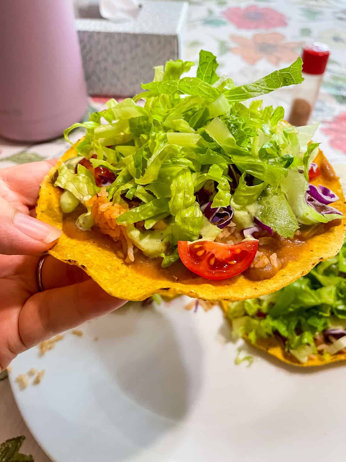 holding the tostada from the side