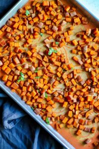 after baking Spicy Roasted Chili Sweet Potatoes on lined tray