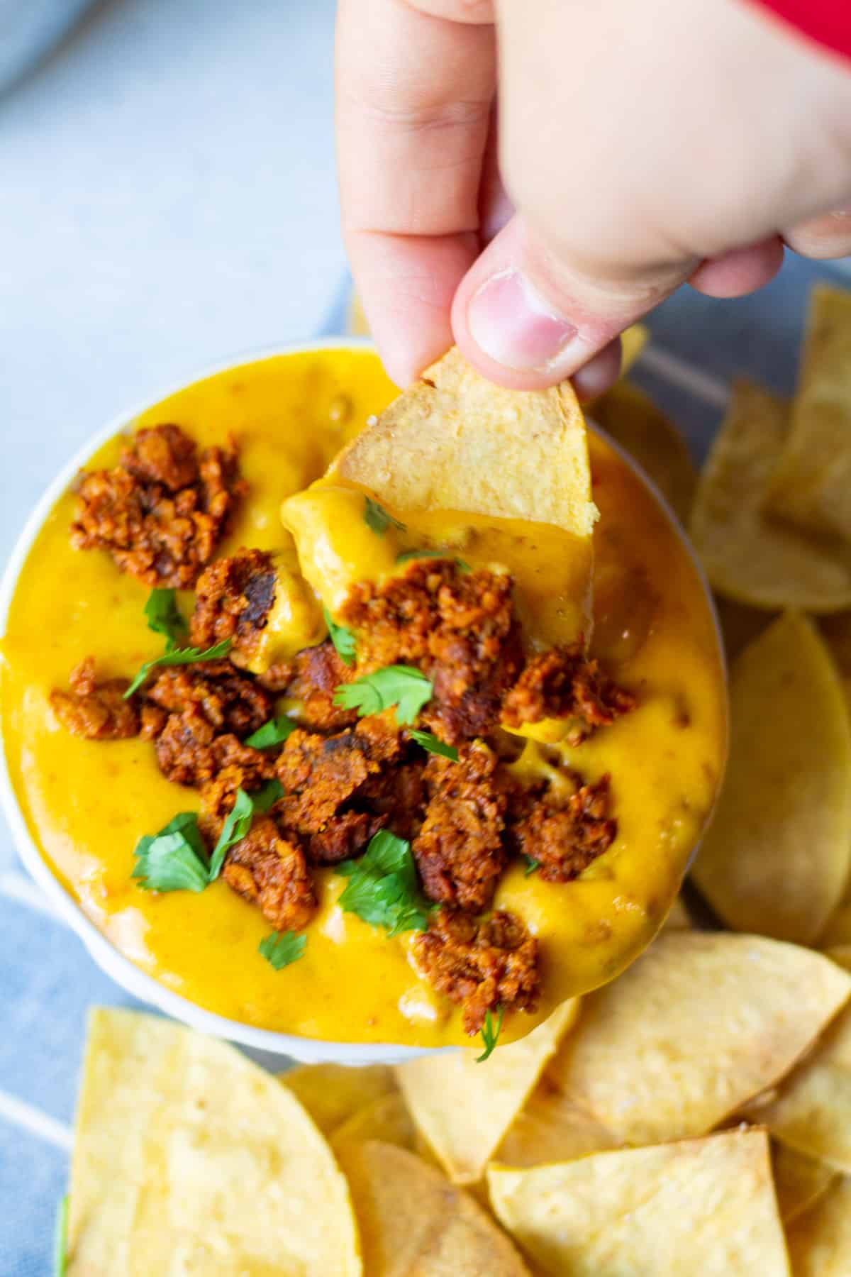dipping chip into choriqueso