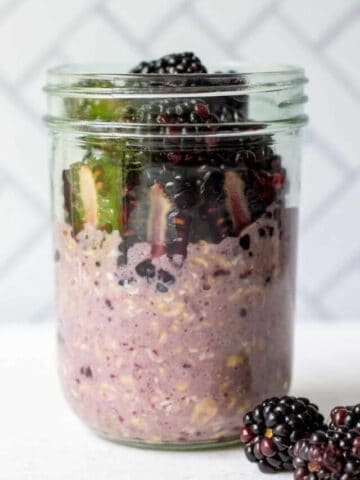 Blackberry overnight oats with jam in a glass mason jar