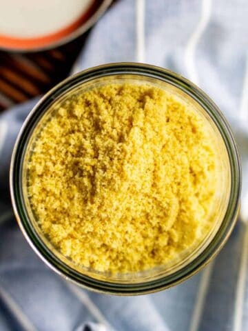 This cheesy, salty, rich and dairy-free parmesan cheese substitute made with almond flour in a jar.