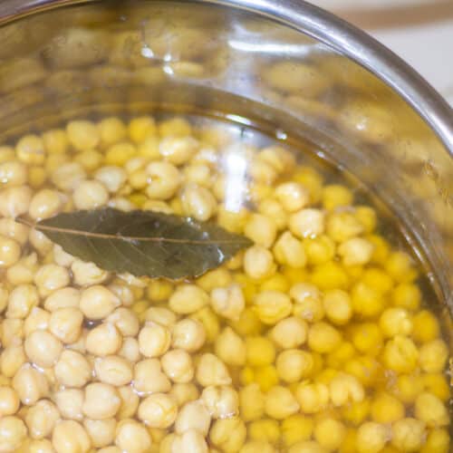 cooked chickpeas with bay leaf in instant pot insert with water